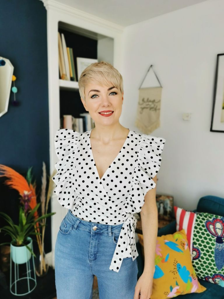 Front-on shot of the Bella Loves Flor cropped wrap around top in black and white polka dot cotton. 